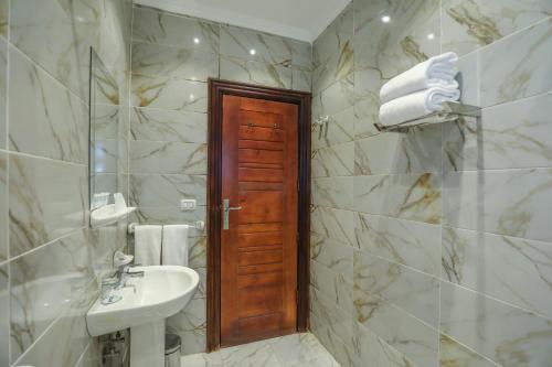 a bathroom with a sink and a mirror at The Palm Hotel in Kafr EL Sheikh