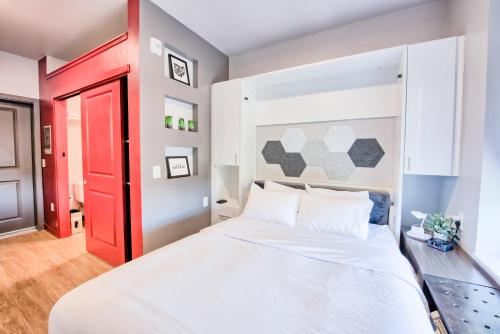 a bedroom with a large bed with a red door at The Urban in Columbus