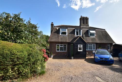 a house with a car parked in front of it at Maytham Cottage in Rye