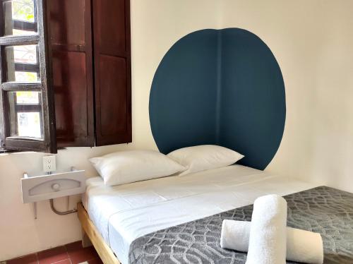 a small bedroom with a bed and a sink at Coliving Chingon in Guadalajara
