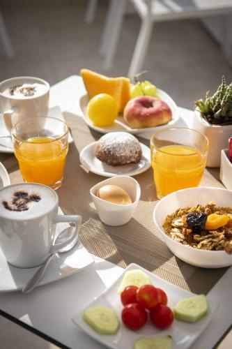 a table topped with plates of breakfast foods and drinks at Magi House Relais in Sorrento