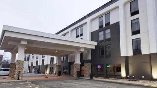 a building with a parking lot in front of it at MainStay Suites Springfield IL in Springfield