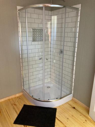 a shower with a glass enclosure in a room at Anglers Paradise in Eersterivierstrand