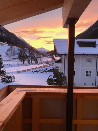 a view from the balcony of a ski lodge with a sunset at Augl‘s Hof in Ischgl