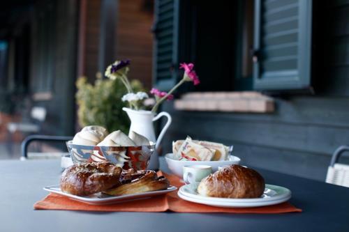 a table with plates of pastries and bowls of food at Due Ponti Village in Cesenatico