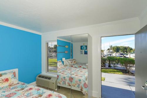 a bedroom with a bed and a large window at Room 127 - Waterfront, Heated Pool, Huge TV, Tiki Bar & Grill in Sarasota