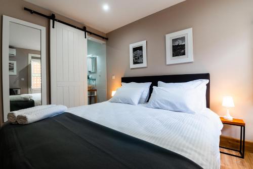 a bedroom with a large bed with white pillows at Monreal Boutique Townhouse - R024RM3 in Paola