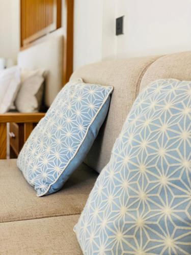 two pillows are sitting on a couch at Lanna Deer Resort Chiang Mai in Chiang Mai