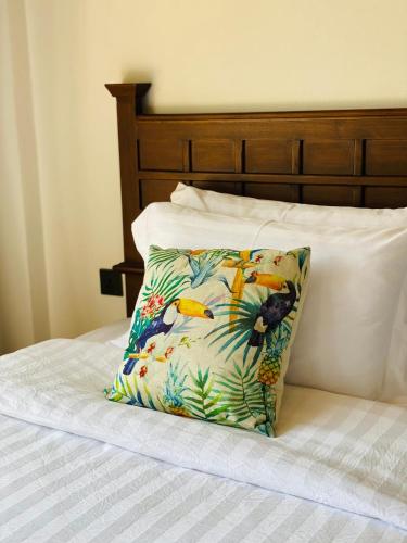 a pillow sitting on top of a bed at Lanna Deer Resort Chiang Mai in Chiang Mai