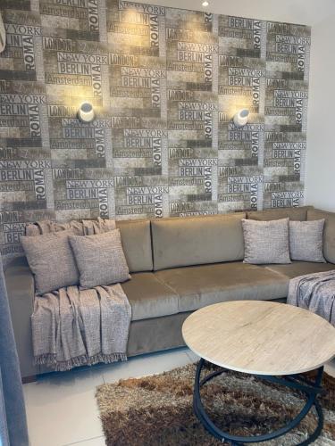 a living room with a couch and a table at CASA MILITOU-NEA FILADELFIA in Athens