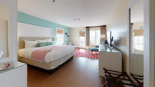 a bedroom with a large bed and a living room at The Hotel Maria in Westerly