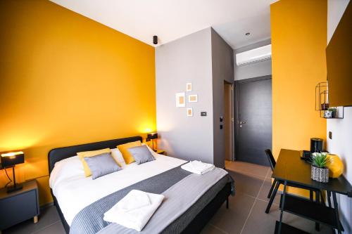 a bedroom with a large bed and a yellow wall at Materdays 24 in Naples