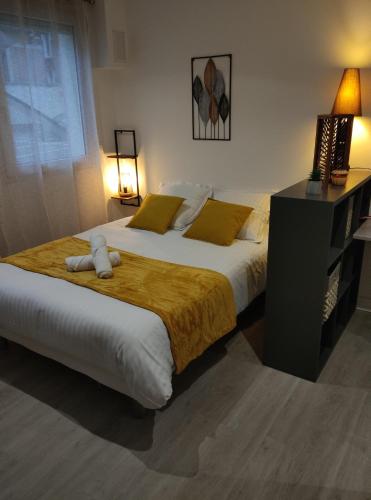 a bedroom with two beds with yellow pillows and a desk at Villa Raphaëlle #4 Centre ville avec parking in Le Havre