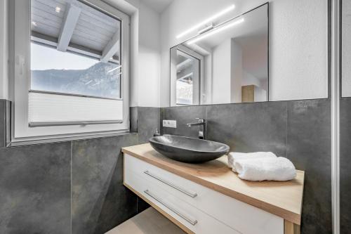 a bathroom with a sink and a mirror at Apart Holzknecht in Längenfeld