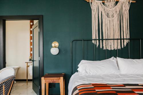 a bedroom with a bed with a green wall at Surf Hotel & Chateau in Buena Vista
