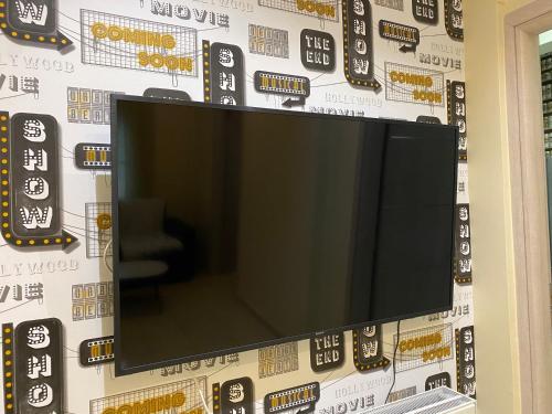 a flat screen tv hanging on a wall at CASA MILITOU-NEA FILADELFIA in Athens