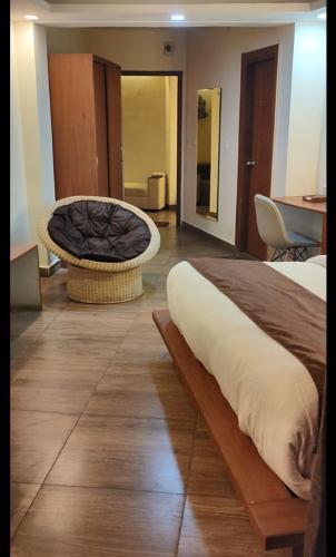 a bedroom with a bed and a table and a chair at Icebergs Mussoorie - A Boutique stay and 24 hrs roof top cafe in Mussoorie