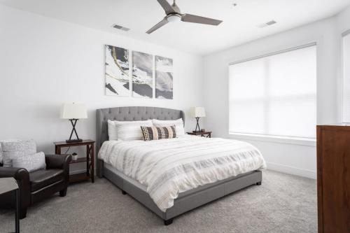 a bedroom with a bed and a chair and a window at Park 302 Downtown in the Heart of Traverse City in Traverse City