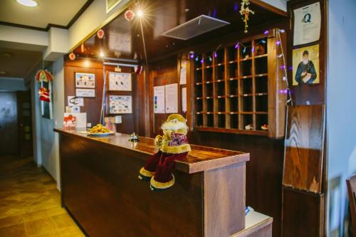 a bar with a figurine sitting at a counter at Grand Hotel Dentro in Konitsa