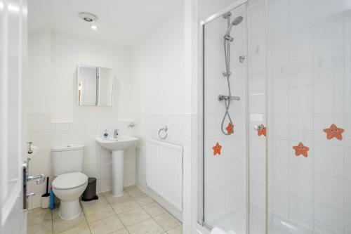 een badkamer met een douche, een toilet en een wastafel bij Stunning 3BR house in Basildon in Basildon