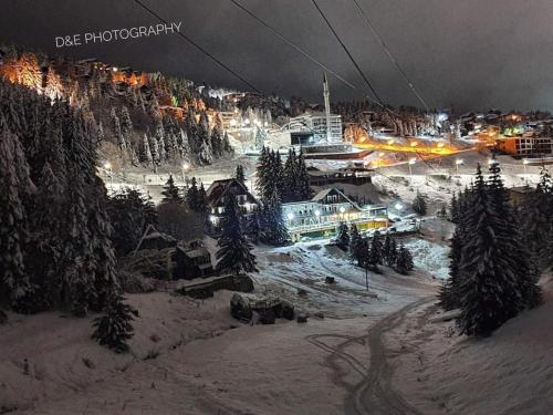 a ski resort lit up at night in the snow at Villa 80 Kodra e Diellit in Tetovo
