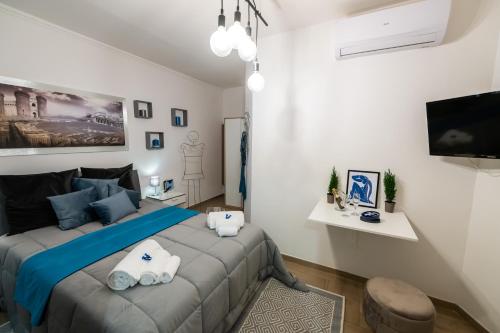 a bedroom with a large bed with blue pillows at Yes I Know My Room - Magica Napoli in Naples