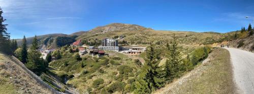 a house on a hill next to a road at Villa 80 Kodra e Diellit in Tetovo