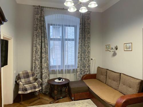 a living room filled with furniture and a window at Kurnakh Apartment in Lviv