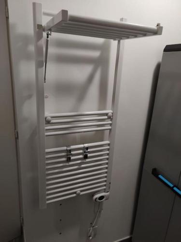 a stainless steel refrigerator freezer in a room at Le Cozy du Poli, Résidence Le Haut des Lacs in Xonrupt-Longemer