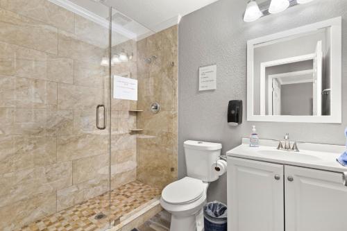 a bathroom with a shower and a toilet and a sink at CYC Eclectic Back House with BBQ Gazebo in San Antonio