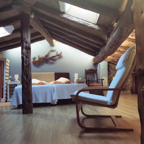 a room with a bed and a chair in it at Casa Rural 1904 in Tubilla del Lago