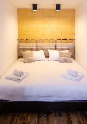 a large white bed with two pillows on it at Rustic House BINA 5 in Gudauri