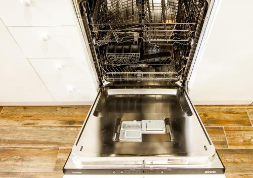 a dishwasher with its door open in a kitchen at Rustic House BINA 5 in Gudauri