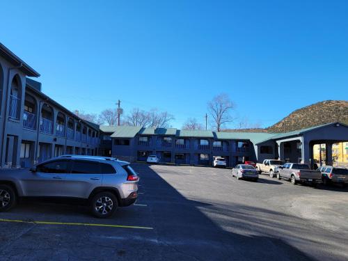 a car parked in a parking lot in front of a building at Days Inn by Wyndham Ruidoso Downs in Ruidoso Downs