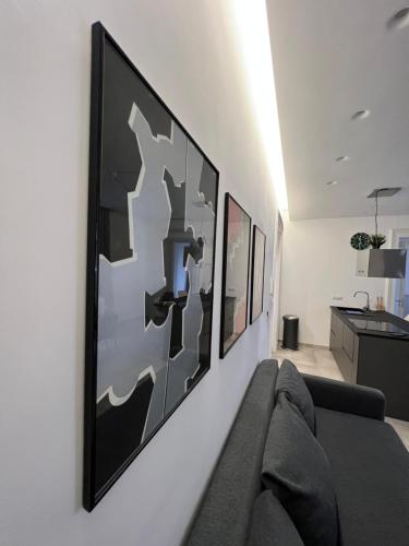 a living room with a couch and pictures on the wall at The Jungle Home in Naples