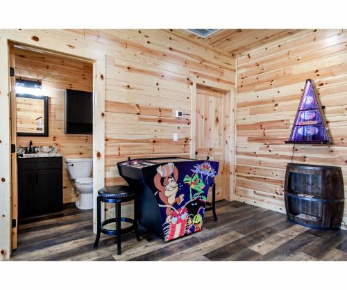 a log cabin bathroom with a christmas tree on the wall at Sky Ridge Mountain View Wheelchair Accessible and Swim Spa in Gatlinburg