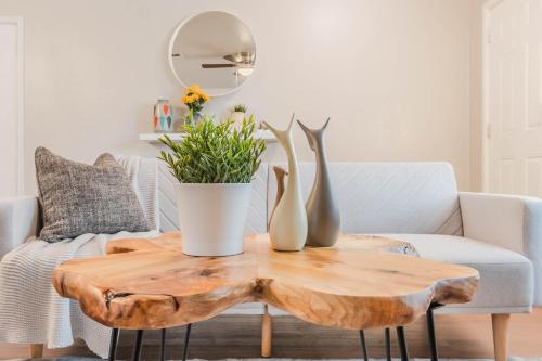 a coffee table with vases on top of it at 3Bedroom 2Bathroom close to historic downtown fast wifi in McKinney