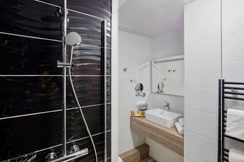 a bathroom with a shower and a sink at Best Western Le Vauban in Prades