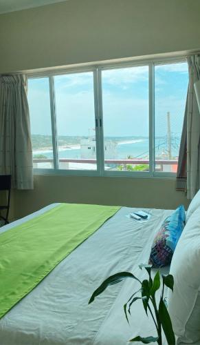 a bedroom with a bed with a view of the ocean at Casa Mia in Puerto Escondido