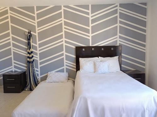 מיטה או מיטות בחדר ב-Apartasuites Britz Holbox