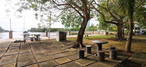 a park with a picnic table and a tree at BayView Villas Condo - Premium Unit in Port Dickson