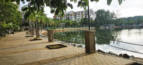 a walkway next to a body of water at BayView Villas Condo - Premium Unit in Port Dickson