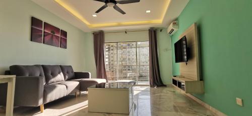 a living room with a couch and a tv at BayView Villas Condo - Premium Unit in Port Dickson