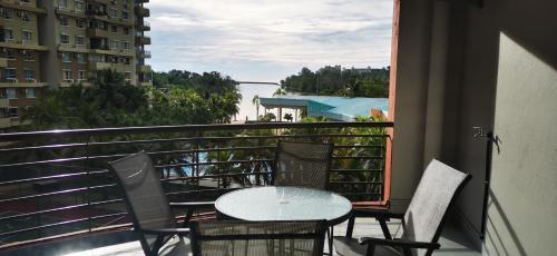 a patio with a table and chairs on a balcony at BayView Villas Condo - Premium Unit in Port Dickson