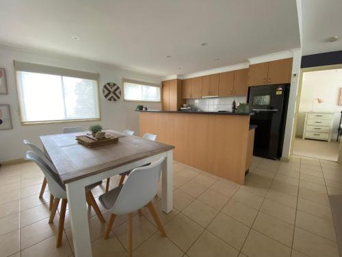 a kitchen and dining room with a table and chairs at Perfect Location in Inverloch