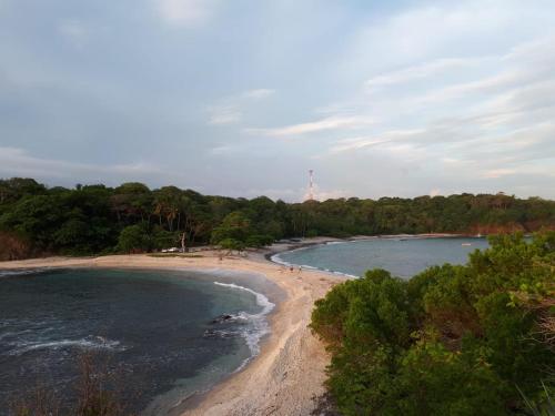 a view of a beach with trees and water at Chalet San Juanillo in San Juanillo