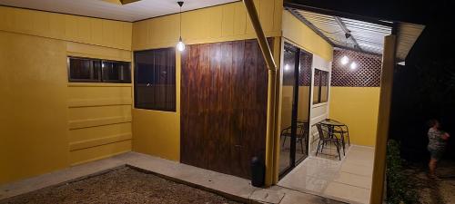 a room with a wooden door and a chair in it at Chalet San Juanillo in San Juanillo