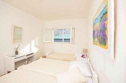 a white room with two beds and a sink at Apartment Croatia Art in Drasnice