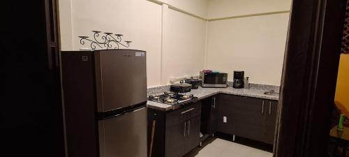 a kitchen with a refrigerator and a stove in it at Chalet San Juanillo in San Juanillo
