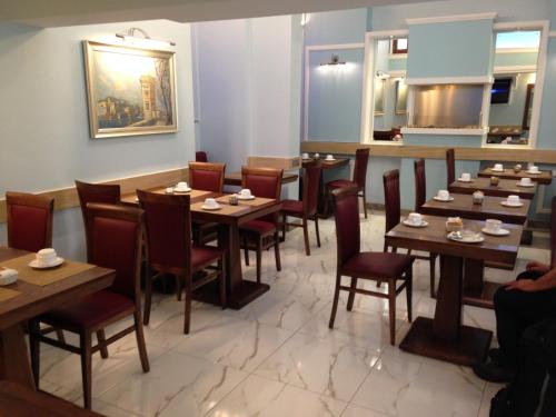 a dining room with wooden tables and chairs at Grand Harbour Hotel in Valletta